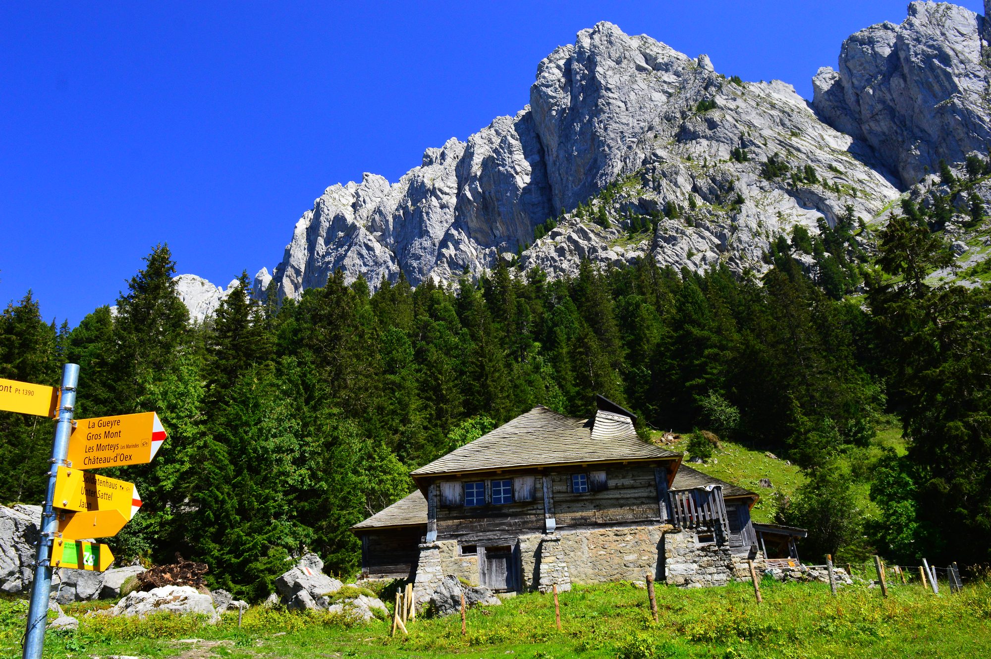 A stone chalet on the alp beneath the Gastlosen cliffs near the Jaunpass